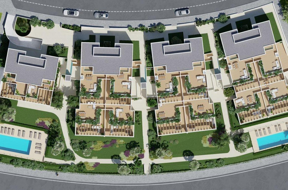 A panoramic view of Font del Llop Golf Course with modern duplex residences and a clear blue sky.
