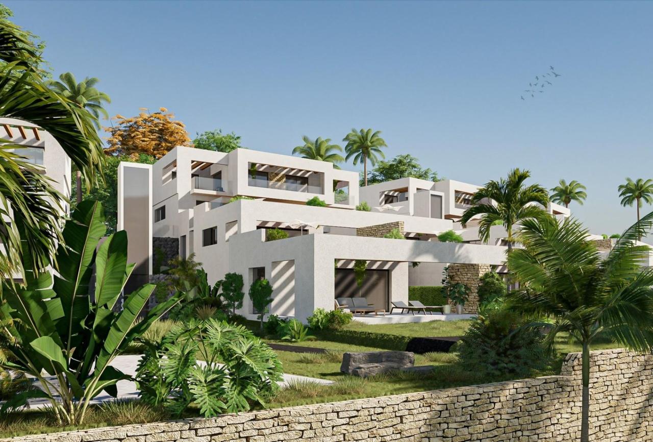 A panoramic view of Font del Llop Golf Course with modern duplex residences and a clear blue sky.
