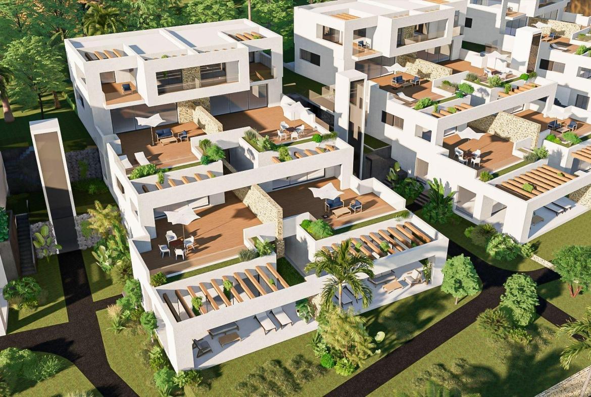 A panoramic view of Font del Llop Golf Course with modern duplex residences and a clear blue sky.