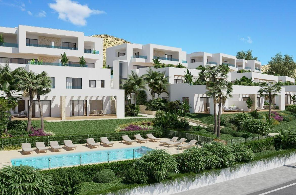 A panoramic view of Font del Llop Golf Course with modern duplex residences and a clear blue sky.