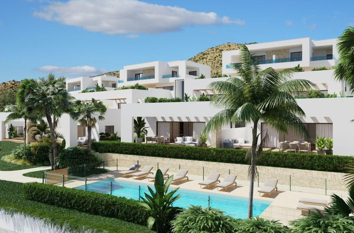 A panoramic view of Font del Llop Golf Course with modern duplex residences and a clear blue sky.