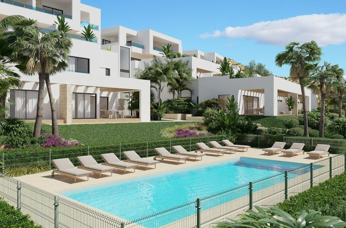 A panoramic view of Font del Llop Golf Course with modern duplex residences and a clear blue sky.