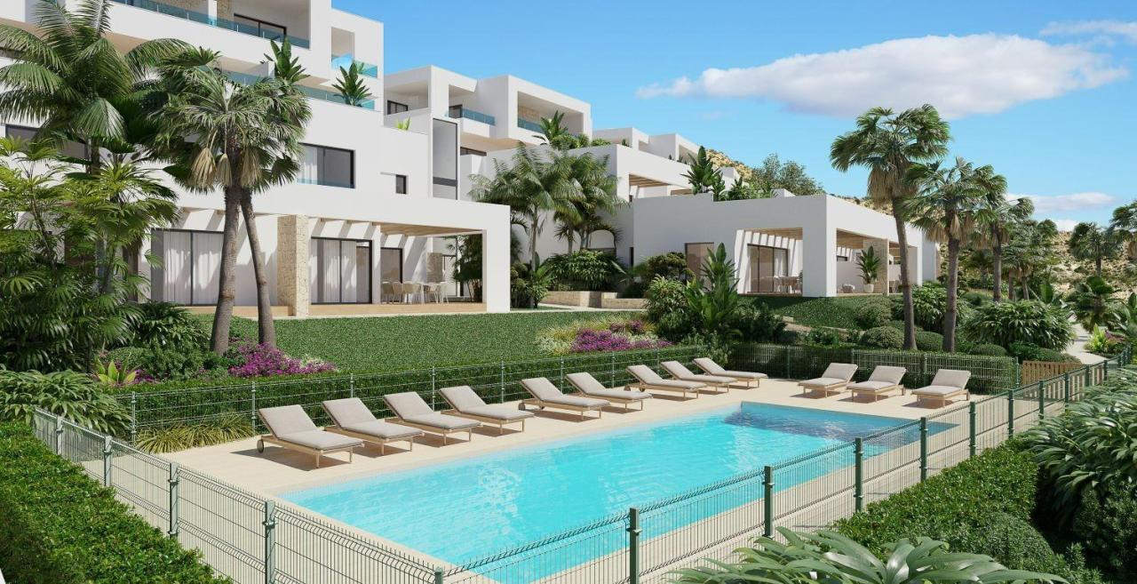 A panoramic view of Font del Llop Golf Course with modern duplex residences and a clear blue sky.