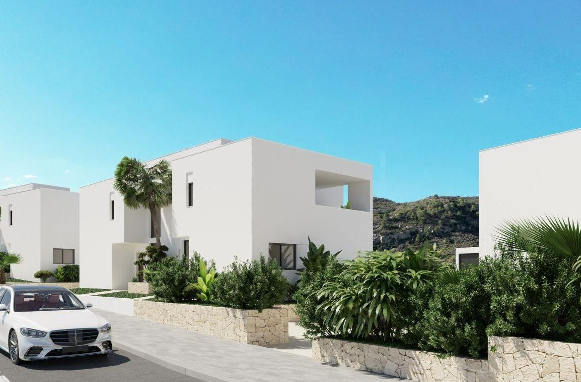 A panoramic view of Font del Llop Golf Course with modern duplex residences and a clear blue sky.