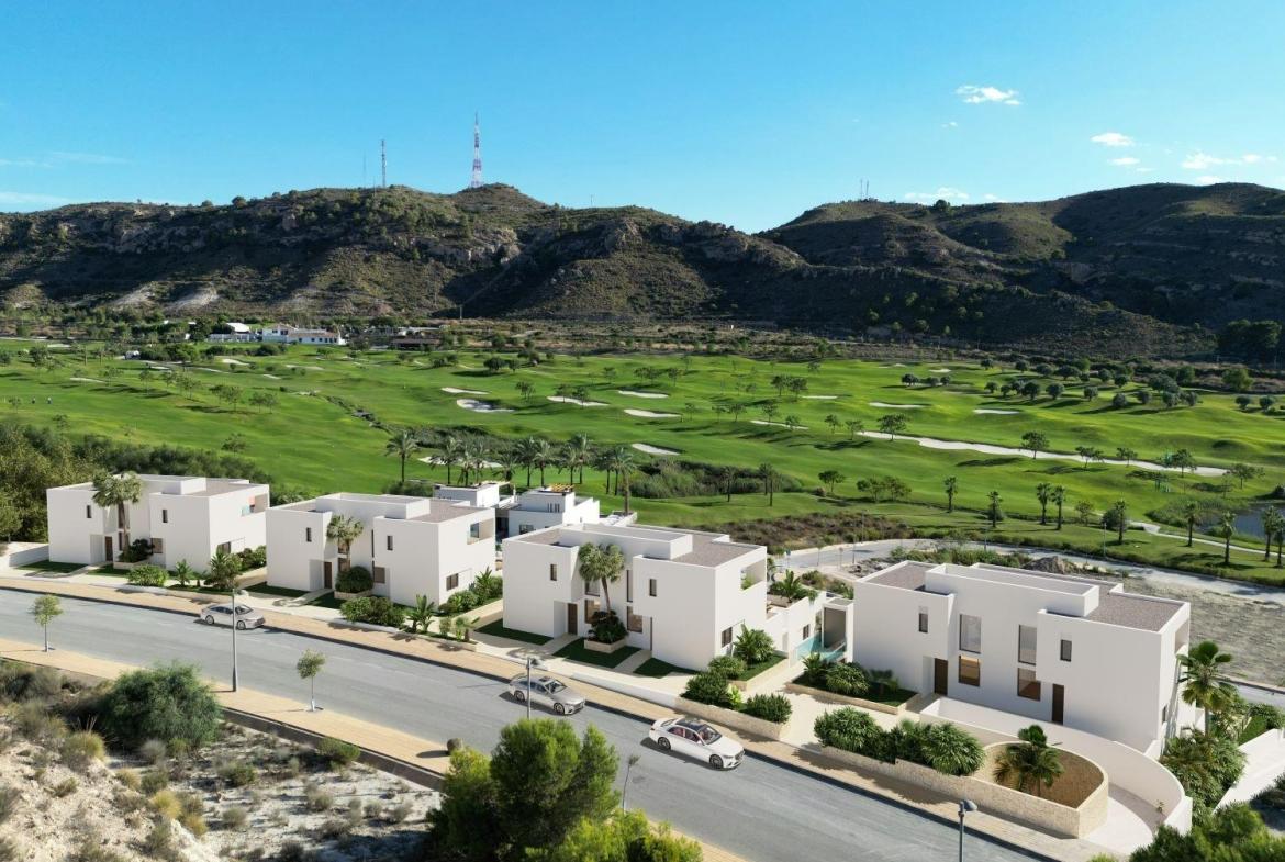 A panoramic view of Font del Llop Golf Course with modern duplex residences and a clear blue sky.