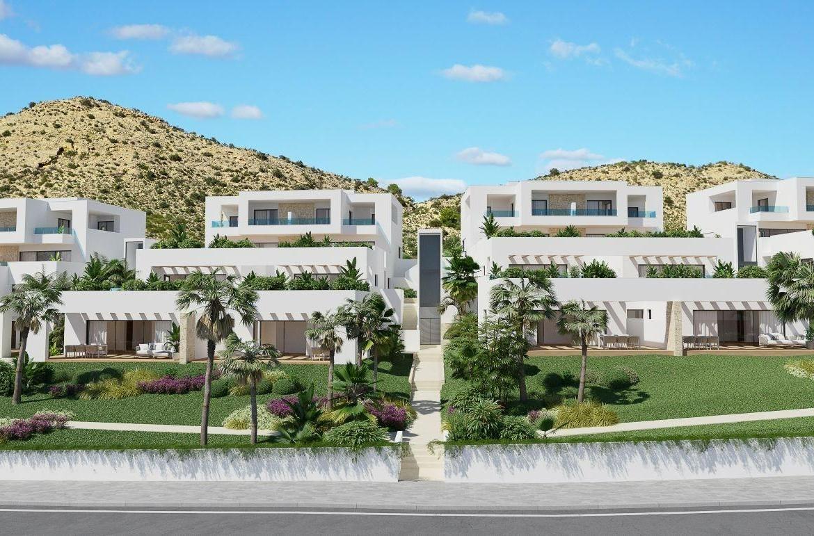 A panoramic view of Font del Llop Golf Course with modern duplex residences and a clear blue sky.