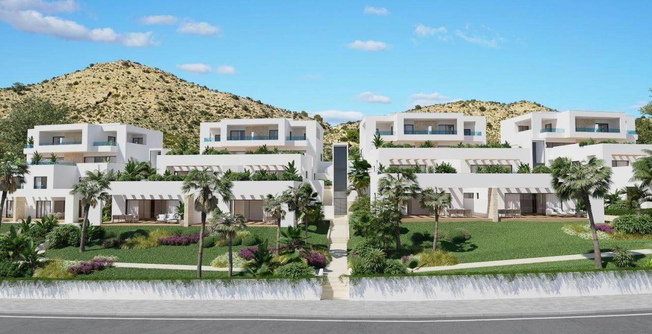 A panoramic view of Font del Llop Golf Course with modern duplex residences and a clear blue sky.