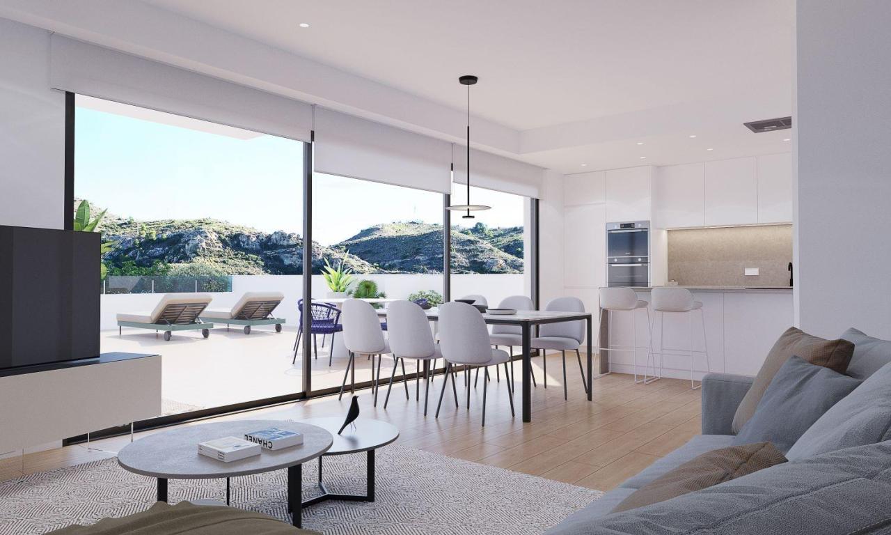 A panoramic view of Font del Llop Golf Course with modern duplex residences and a clear blue sky.