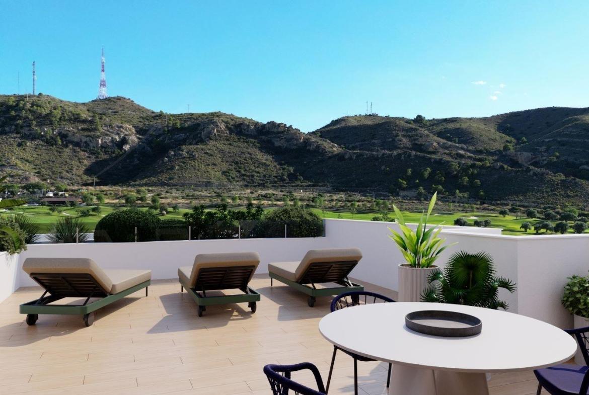 A panoramic view of Font del Llop Golf Course with modern duplex residences and a clear blue sky.