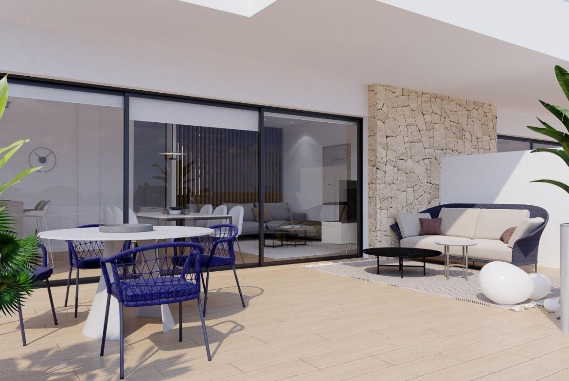 A panoramic view of Font del Llop Golf Course with modern duplex residences and a clear blue sky.