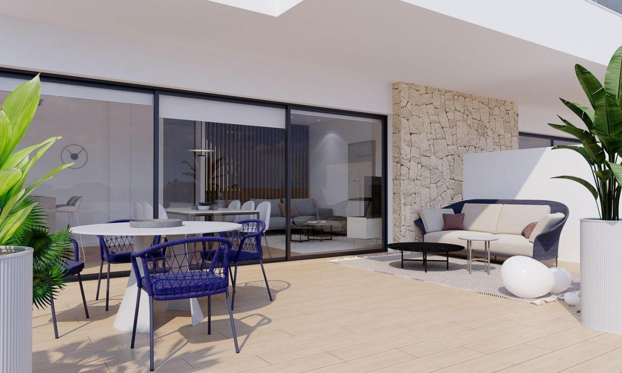 A panoramic view of Font del Llop Golf Course with modern duplex residences and a clear blue sky.