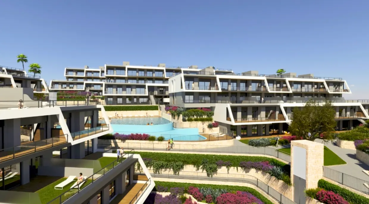 Modern apartment complex in Spain with terraces and a pool.