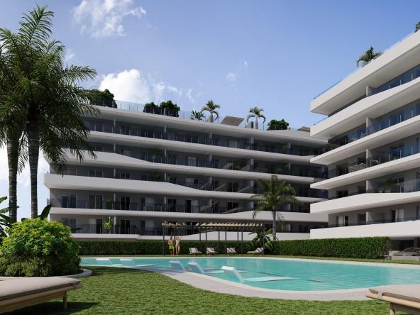 Aerial view of a modern residential complex with a swimming pool near the beach and golf courses in Costa Blanca, Spain.