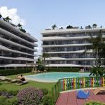 Aerial view of a modern residential complex with a swimming pool near the beach and golf courses in Costa Blanca, Spain.