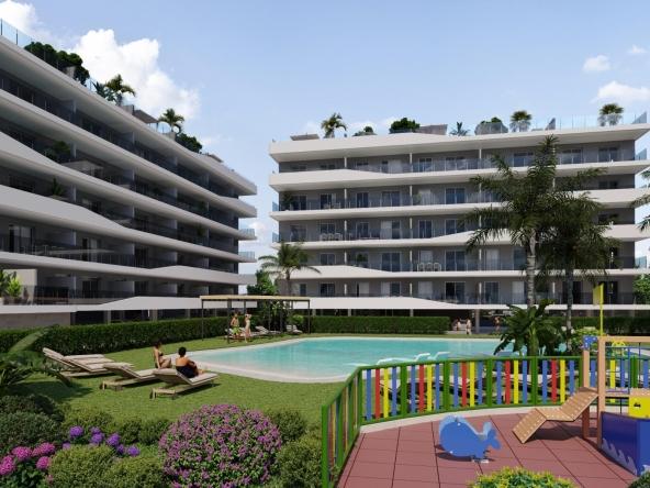 Aerial view of a modern residential complex with a swimming pool near the beach and golf courses in Costa Blanca, Spain.